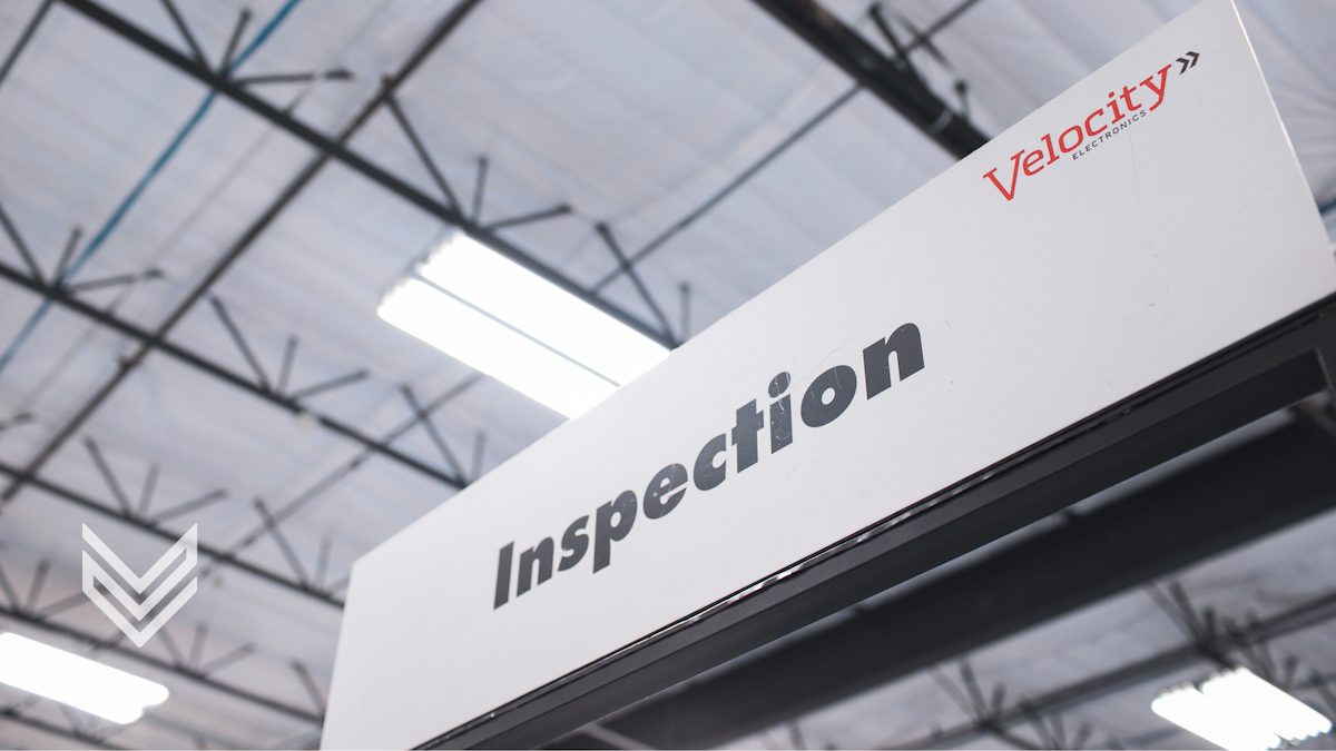 A sign reading "inspection" at Velocity Electronics' facility