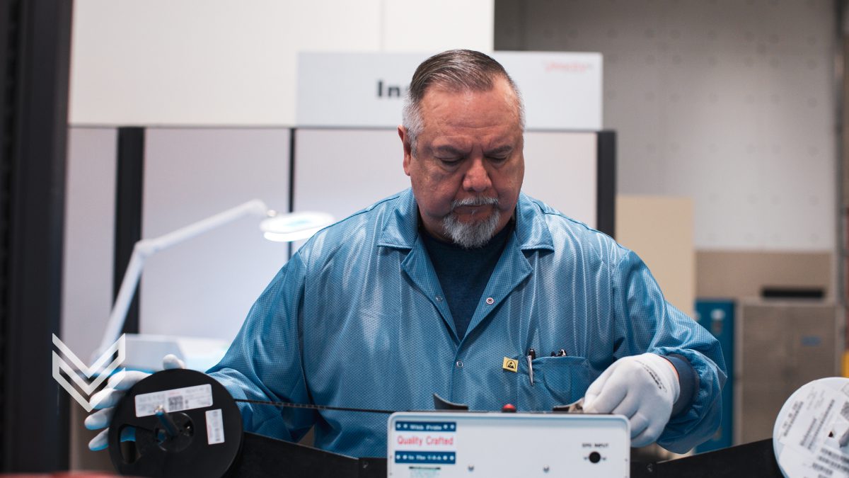 A Velocity quality inspector examines components with specialized equipment.